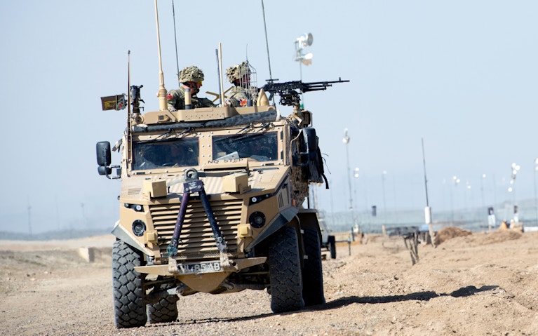 Military vehicle with soldiers driving