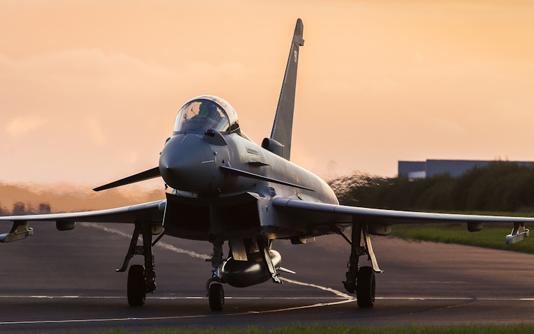 Backlit RAF Typhoon taxis out for takeoff