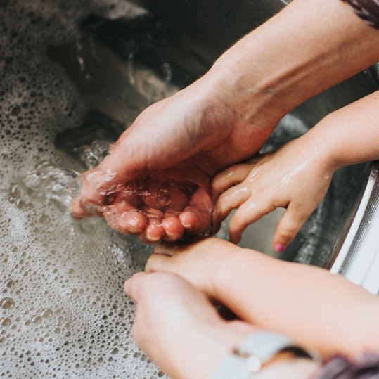 hands in a sink full of water