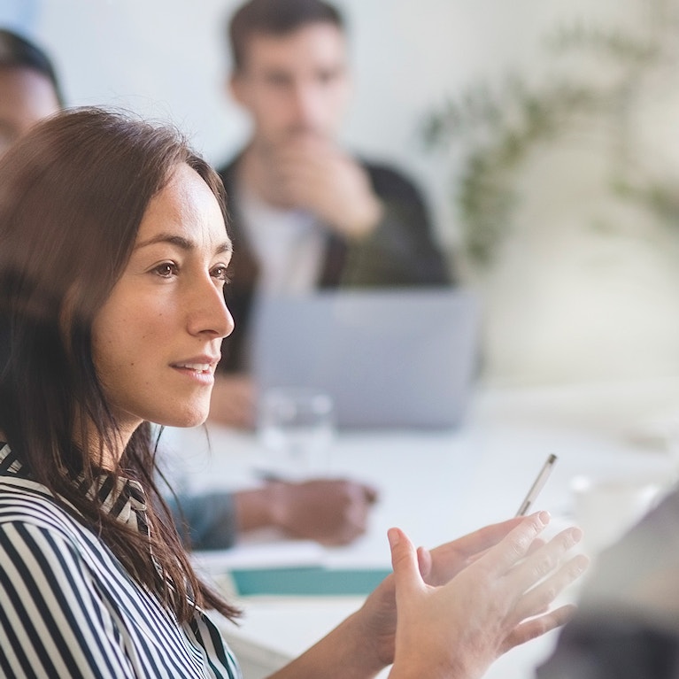 Woman taking in a group meeting.