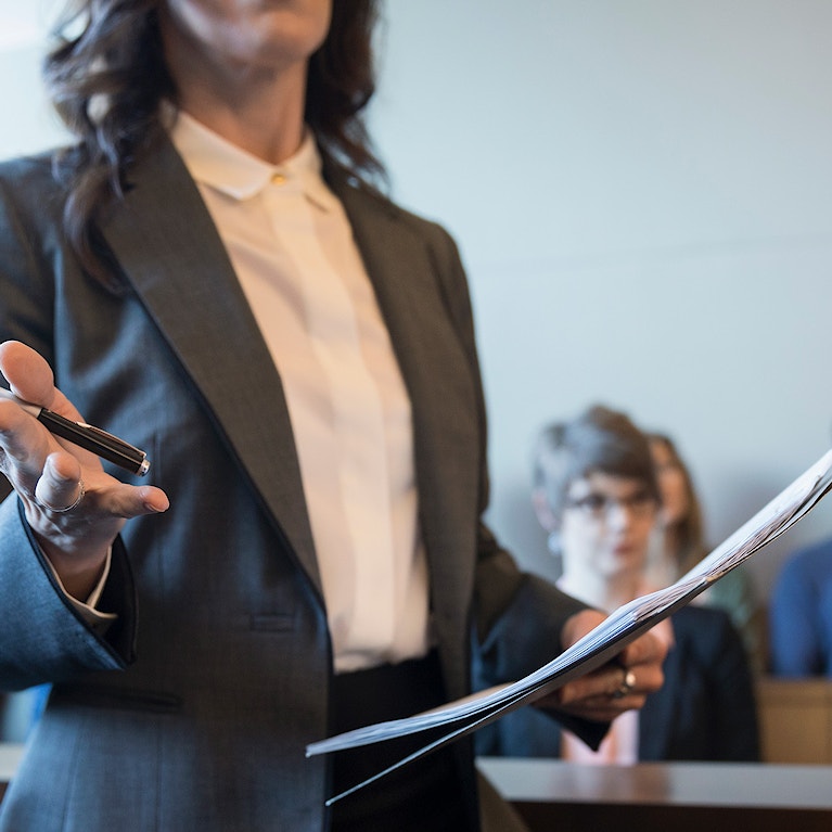 A woman speaking in a court room