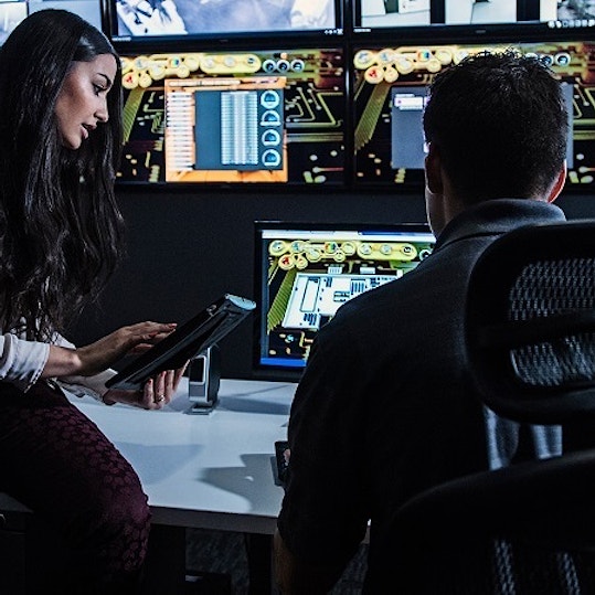 Colleagues working in front of multiple screens