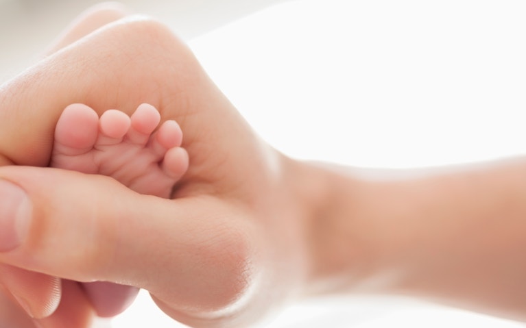 holding a baby feet