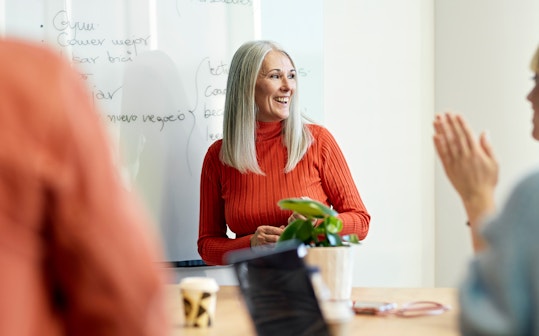 Woman presenting to a team.