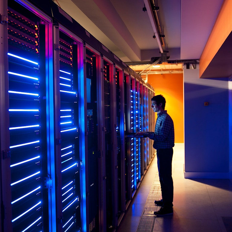 Man standing by data servers.