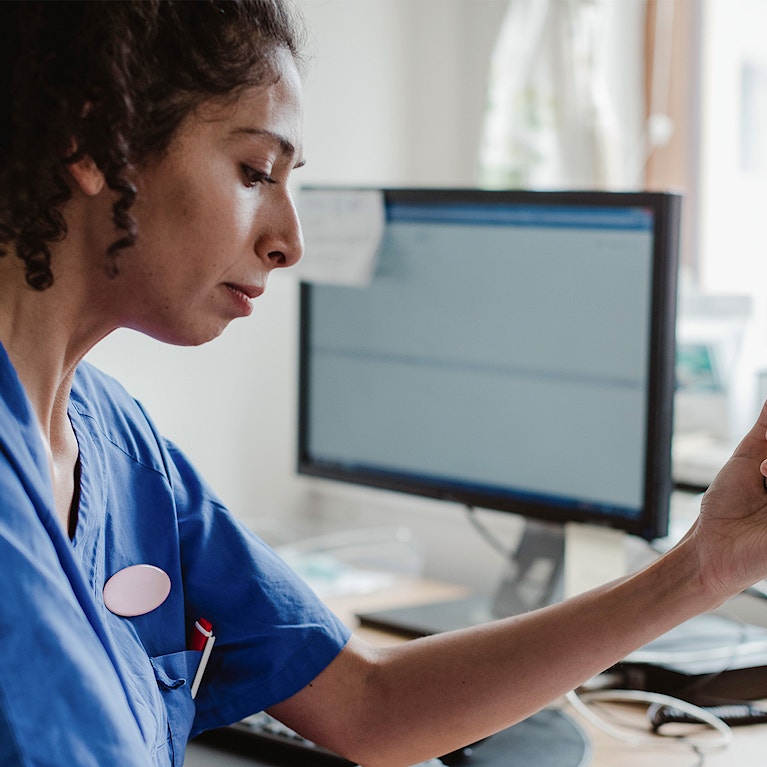 nurse or doctor holding a photo sitting at work a desk