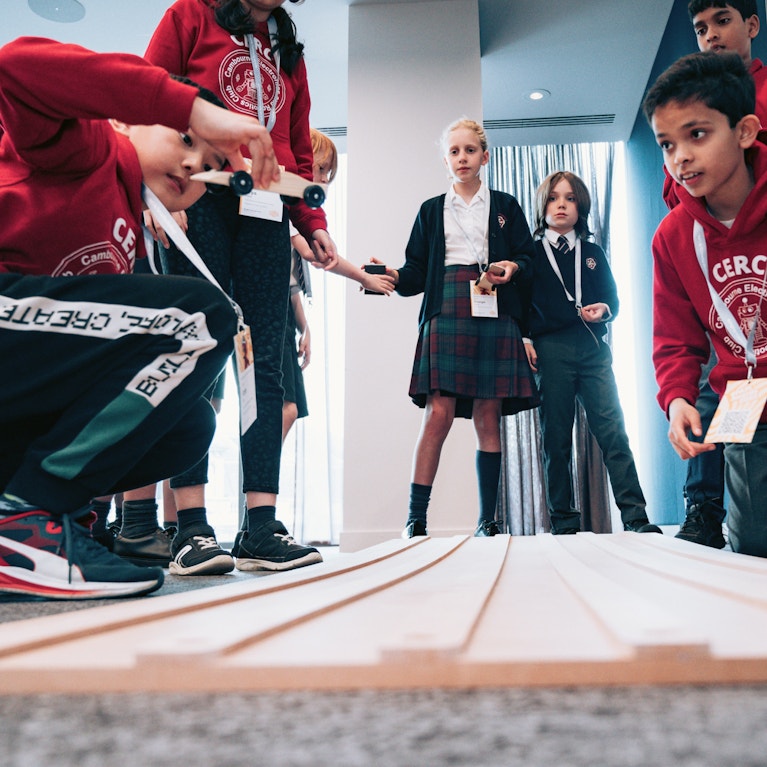 School children gathered around an activity