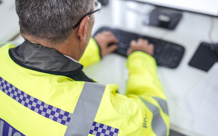 British police officer writing a report