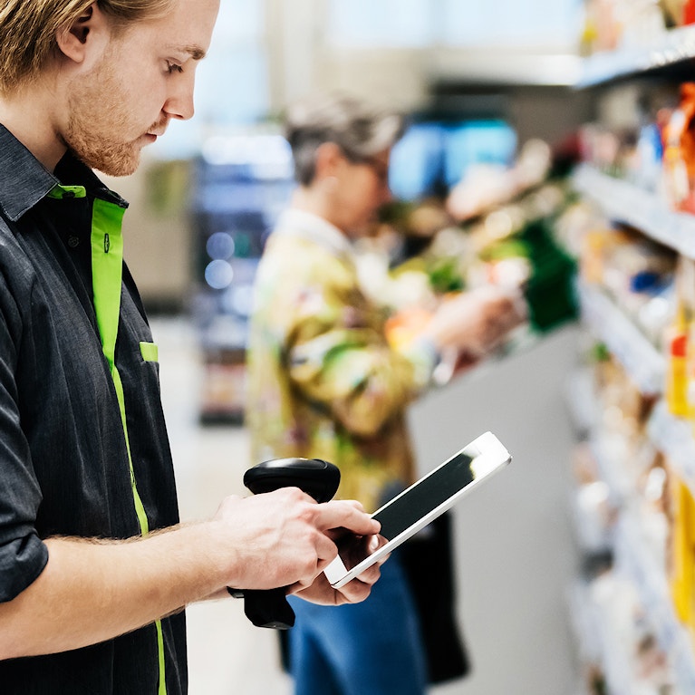 Supermarket employee performing stock check