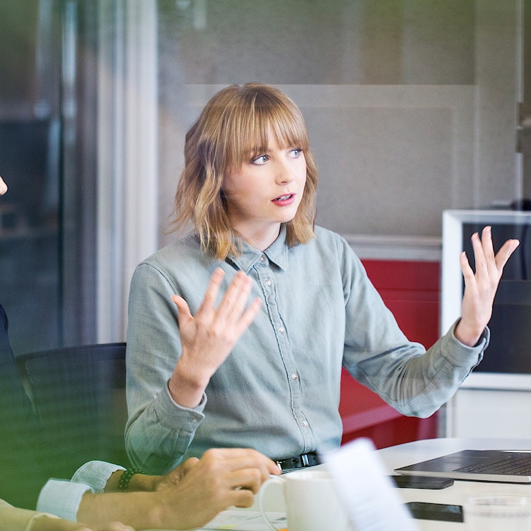 Colleagues discussing in a meeting room.