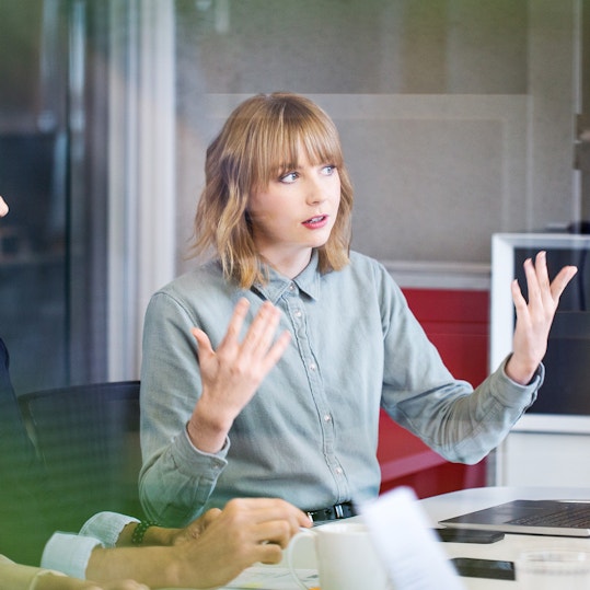 Colleagues discussing in a meeting room.