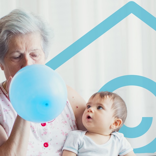 Grandmother inflating a balloon for grandchild