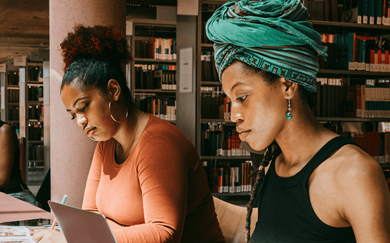 Group of university students studying in library