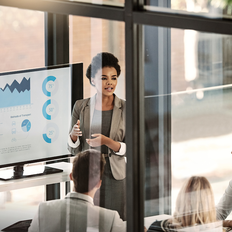 Woman presenting to team at work