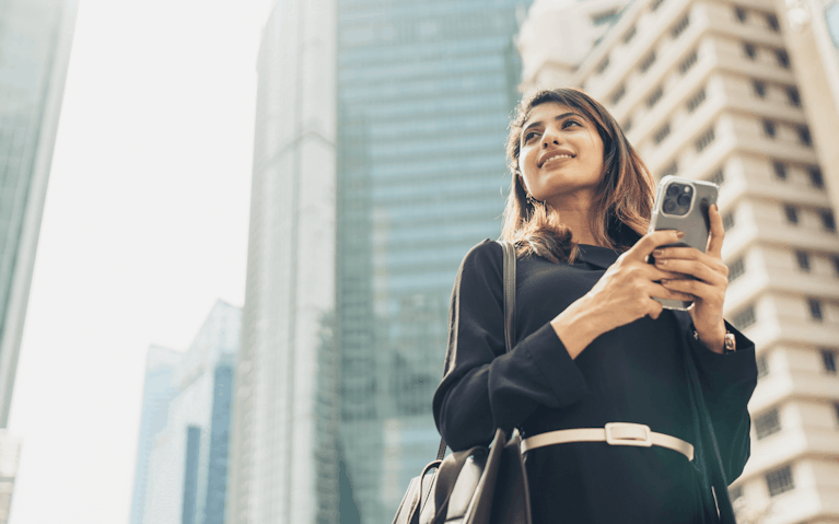 Business woman using smartphone in city