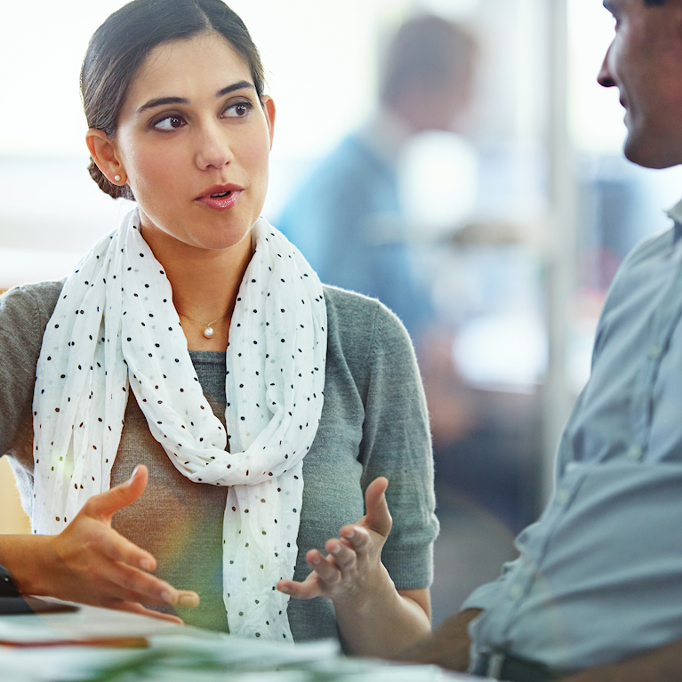 Two people sitting next to each other in an office